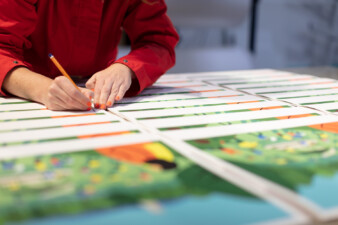 Fuchsia MacAree signing prints of 'Like The Sun Coming Out'